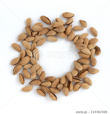 heap of unpeeled almonds isolated on white background heap of unpeeled almonds isolated on white background 114362366