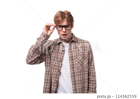 young european man with golden hair wearing glasses and a shirt looking at the camera young european man with golden hair wearing glasses and a shirt looking at the camera 114362559