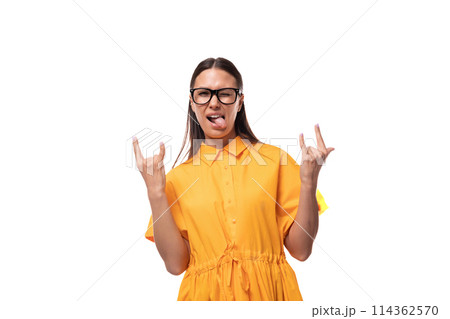 european young brunette lady dressed in orange summer dress shows cool gesture 114362570