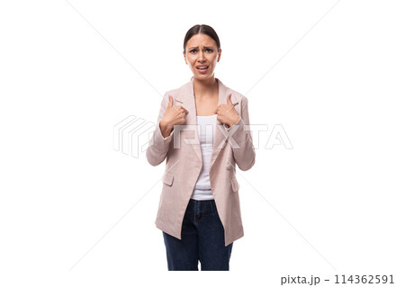 portrait of a young slender brunette business woman with ponytail dressed in a jacket and jeans 114362591
