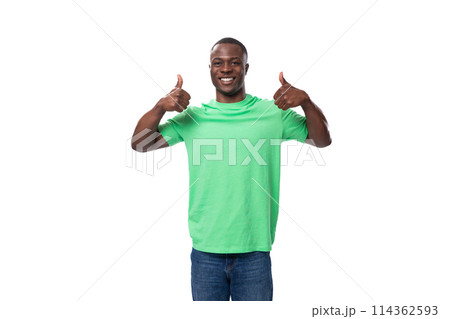 young american man dressed in a green corporate t-shirt on a white background with copy space 114362593