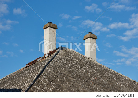 Chimneys on a house old roof Chimneys on a house old roof 114364191