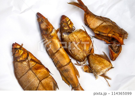 Smoked freshwater zander, pike and common bream fish for home use on white paper.. Smoked freshwater zander, pike and common bream fish for home use on white paper.. 114365099
