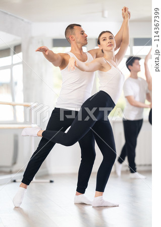 Young man and young woman rehearsing pair ballet Young man and young woman rehearsing pair ballet 114367399