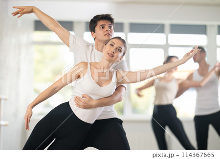 Young guy and young woman rehearsing pair ballet 114367665