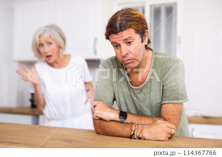 Upset man dont speaking after discord with aged wife behind 114367766