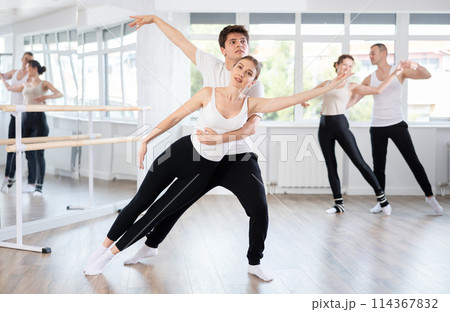 Young guy and young woman rehearsing pair ballet 114367832