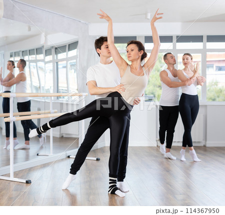Young guy and adult woman rehearsing pair ballet Young guy and adult woman rehearsing pair ballet 114367950