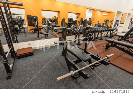 Exercise equipment in an empty gym Exercise equipment in an empty gym 114371813