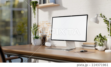 A contemporary minimalist home office features a computer mockup against a white rustic brick wall. A contemporary minimalist home office features a computer mockup against a white rustic brick wall. 114371961