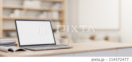 A laptop computer mockup on a minimal wooden table in a contemporary luxurious home office. 114372477