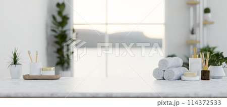 A luxury white marble tabletop features toiletries and a copy space in a modern white bathroom. A luxury white marble tabletop features toiletries and a copy space in a modern white bathroom. 114372533