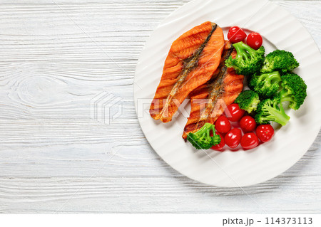grilled salmon steaks with broccoli and tomatoes grilled salmon steaks with broccoli and tomatoes 114373113