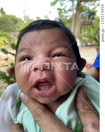 Newborn baby girl looking at camera with open mouth and tongue out Newborn baby girl looking at camera with open mouth and tongue out 114373459
