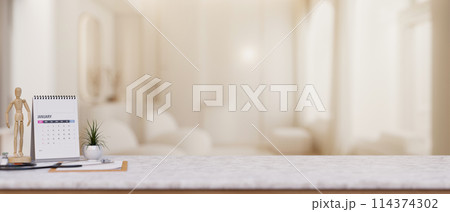 A doctor's office desk features a space on the white marble desk in a modern luxurious clinic lounge A doctor's office desk features a space on the white marble desk in a modern luxurious clinic lounge 114374302