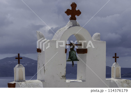 Greece, Santorini, Oia, Traditional white bell tower of church with red crosses 114376179