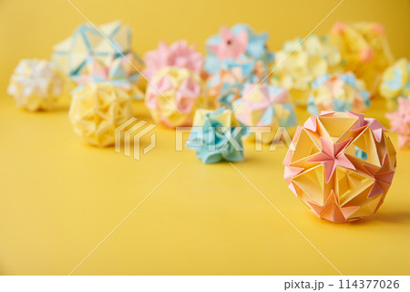 Set of multicolor handmade modular origami balls or Kusudama Isolated on yellow background. 114377026