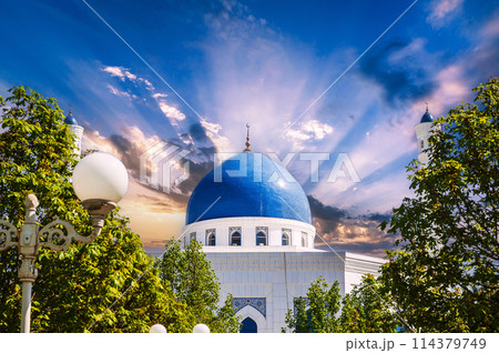 blue dome of modern white marble Islamic Masjid Minor Mosque in Tashkent in Uzbekistan on background of the sunset sky in summer blue dome of modern white marble Islamic Masjid Minor Mosque in Tashkent in Uzbekistan on background of the sunset sky in summer 114379749