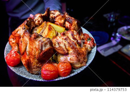 Grilled chicken with baked potatoes and tomatoes Grilled chicken with baked potatoes and tomatoes 114379753
