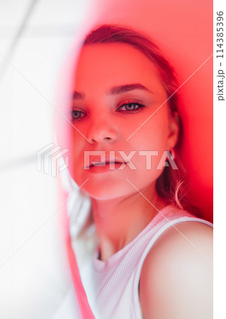 Portrait of pleasant-looking Caucasian female in pink colors 114385396