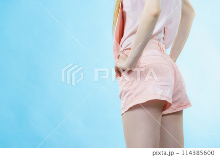 Woman in dungarees back view Woman in dungarees back view 114385600