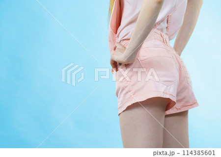 Woman in dungarees back view Woman in dungarees back view 114385601
