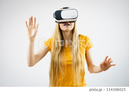 Girl wearing virtual reality goggles. Girl wearing virtual reality goggles. 114386025