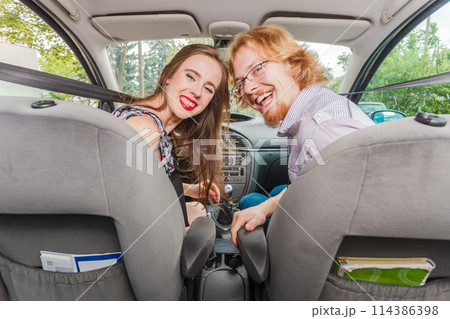 Happy man and woman in car 114386398