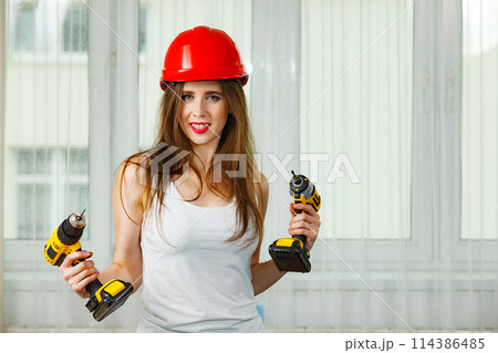 Woman using power driil for work at home Woman using power driil for work at home 114386485