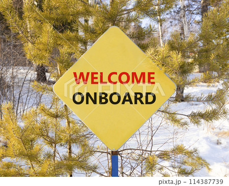 Welcome onboard symbol. Concept words Welcome onboard on beautiful yellow road sign. Beautiful forest snow blue sky background. Business, motivational welcome onboard concept. Copy space. Welcome onboard symbol. Concept words Welcome onboard on beautiful yellow road sign. Beautiful forest snow blue sky background. Business, motivational welcome onboard concept. Copy space. 114387739