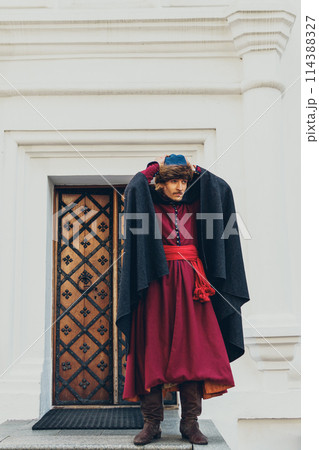 Portrait of a man in a medieval middle class costume. Retro style and historical clothes concepts Portrait of a man in a medieval middle class costume. Retro style and historical clothes concepts 114388327