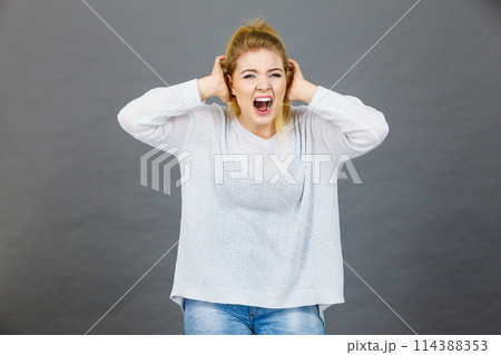 Unhappy woman screaming and yelling in pain Unhappy woman screaming and yelling in pain 114388353