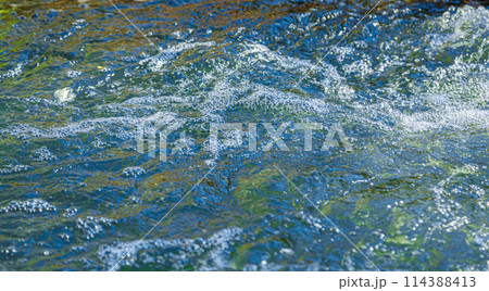 flow of water and spray from a stone 114388413