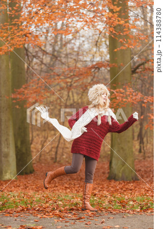 Fashion woman running in fall autumn park forest. Fashion woman running in fall autumn park forest. 114388780