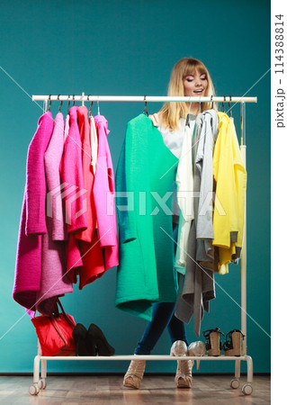 Woman choosing clothes to wear in mall or wardrobe Woman choosing clothes to wear in mall or wardrobe 114388814