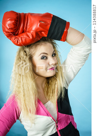 Funny girl in red gloves playing sports boxing 114388817
