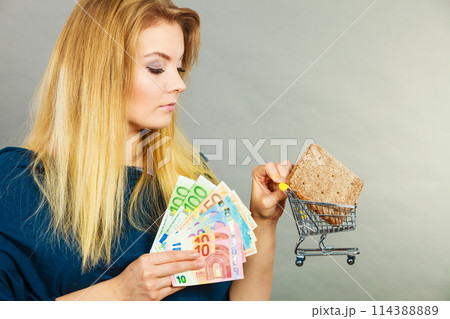 Woman holding shopping basket with bread 114388889