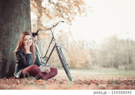 Girl under tree with bike. Girl under tree with bike. 114389343