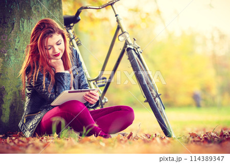 Girl under tree with bike. Girl under tree with bike. 114389347