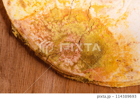 Rotten bread on table. 114389693