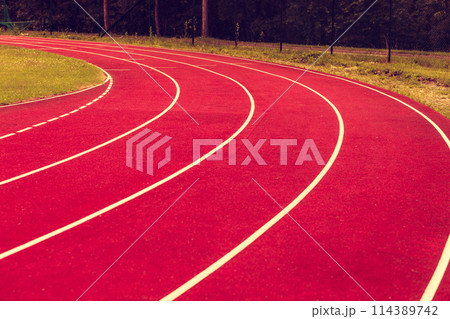 Red running track in stadium. 114389742