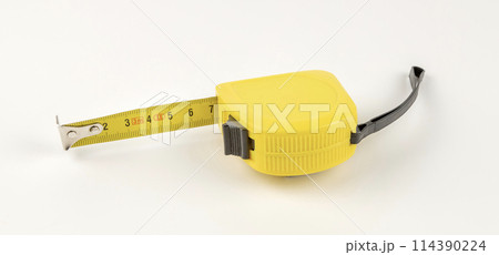 Yellow tape measure. The concept of measuring lengths. 114390224