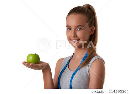 Portrait of a happy fitness woman holding apple and measuring tape isolated over white background 114395564