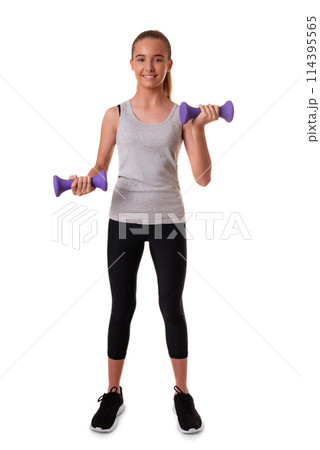 Full length of satisfied motivated teen girl has regular training raises arms with dumbbells does exercises for muscles dressed in sportswear isolated on white 114395565