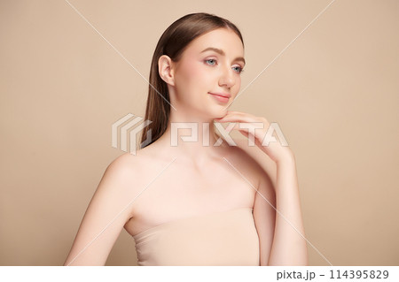 Beautiful young woman with clean fresh skin on beige background, Face care, Facial treatment, Cosmetology, beauty and spa, women portrait. Beautiful young woman with clean fresh skin on beige background, Face care, Facial treatment, Cosmetology, beauty and spa, women portrait. 114395829
