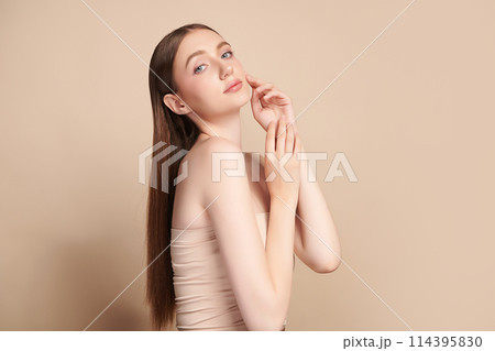 Beautiful young woman with clean fresh skin on beige background, Face care, Facial treatment, Cosmetology, beauty and spa, women portrait. 114395830