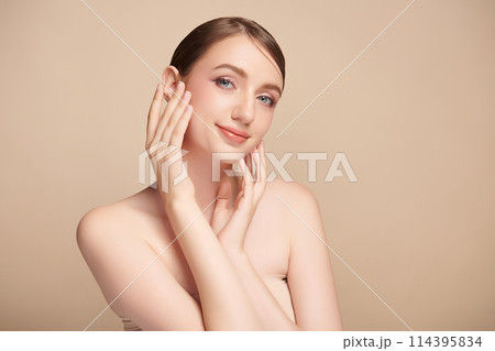 Beautiful young woman with clean fresh skin on beige background, Face care, Facial treatment, Cosmetology, beauty and spa, women portrait. 114395834