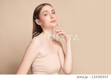 Beautiful young woman with clean fresh skin on beigge background, Face care, Facial treatment, Cosmetology, beauty and spa, women portrait. 114395837