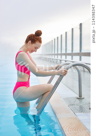 awesome happy ginger woman looking at her legs 114398347