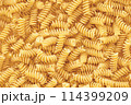 Stack of Uncooked Fusilli, Abstract Backdrop. 114399209